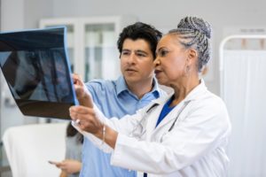 Podiatrist and patient reviewing X-ray results