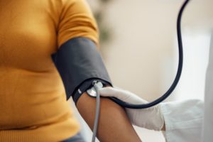 Patient receiving blood pressure test to diagnose if they have hypertension