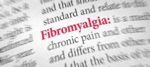 Word “fibromyalgia” in red, listed in dictionary