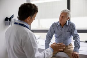 Doctor talking to a patient sitting on exam table