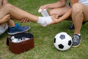 Athlete receiving first aid after injury during soccer