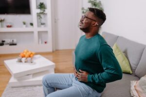 Young person experiencing abdominal pain